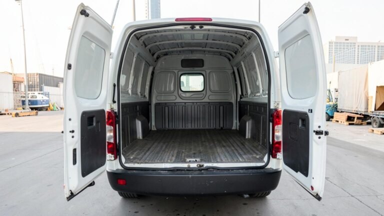 Toyota Hiace panel van with the rear doors open, showing the empty load bay