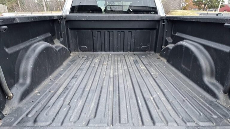 Empty open bed of the 1-ton pickup, loaded over the side or off the back
