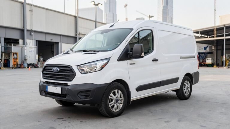 White Ford Transit panel van for rent in Dubai, front three-quarter view