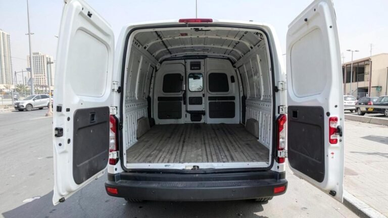 Ford Transit panel van with the rear doors open, showing the empty load bay