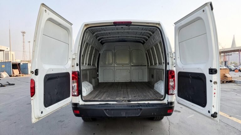 Nissan Urvan panel van with the rear doors open, showing the empty load bay